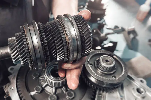 Cross-section of a car gearbox. mechanic work in the garage.