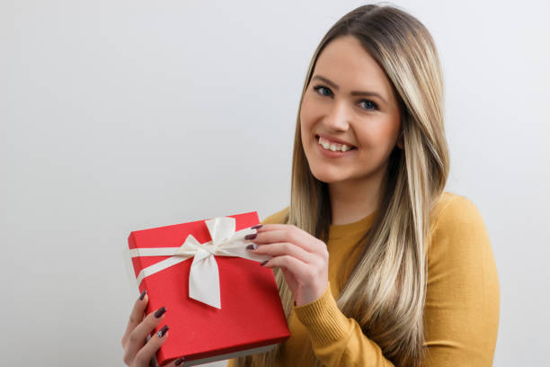 istock Pretty young girl holding a gift box. 696752452