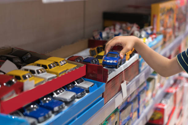 Boy choosing toy in the shop Boy choosing toy in the shop toy store stock pictures, royalty-free photos & images