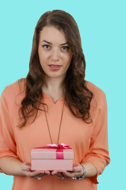 istock Pretty young girl holding a gift box. 696752636