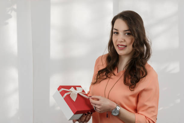 istock Pretty young girl holding a gift box. 696753396
