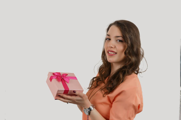 istock Pretty young girl holding a gift box. 696753510