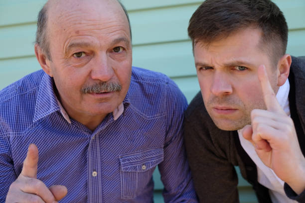 istock Satisfied men showing index finger up, giving advice 696756000