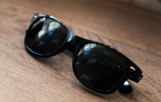 istock Black warfarrer sunglasses on a wooden table 696756714