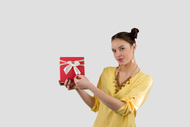 istock Pretty young girl holding a gift box. 696759546