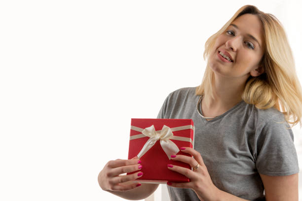 istock Pretty young girl holding a gift box. 696760124