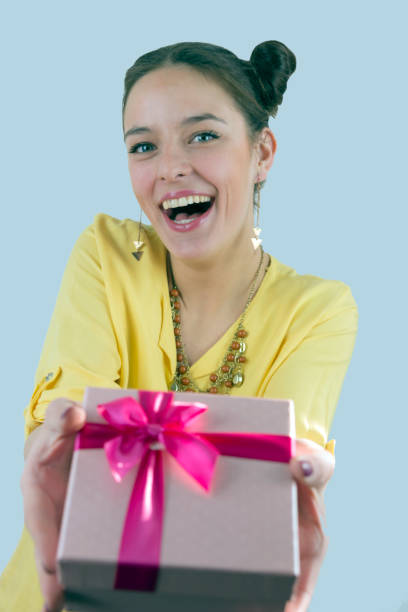 istock Pretty young girl holding a gift box. 696760644