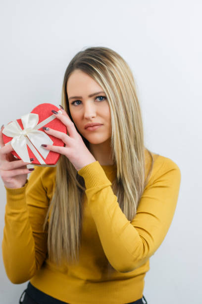 istock Pretty young girl holding a gift heart. 696763164