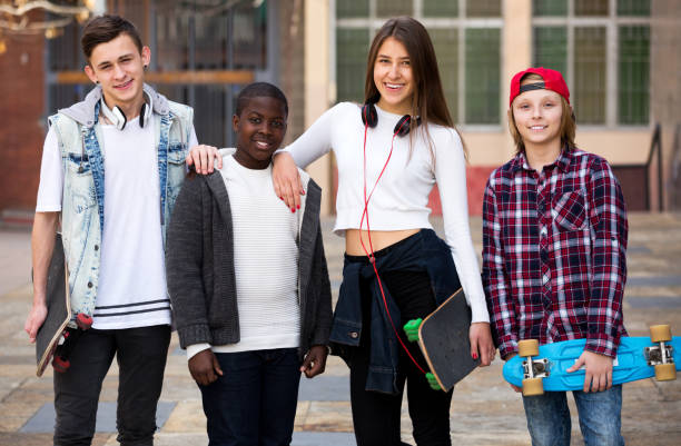 istock Teenagers with skateboards posing in town square 696793908