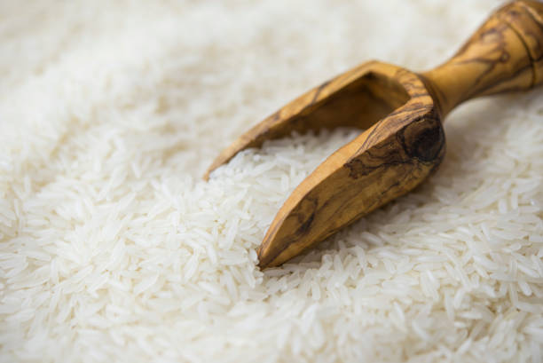 Jasmine rice in a wooden bowl stock photo