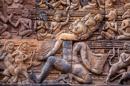 Detail of the elaborate decorative wall carvings of the 10th Century Banteay Srei, a temple complex dedicated to the Hindu god Shiva.