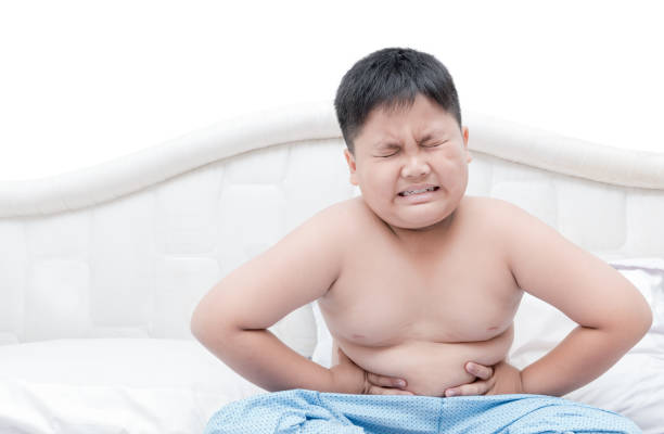istock Obese fat boy overweight stomachache on bed isolated 696799530