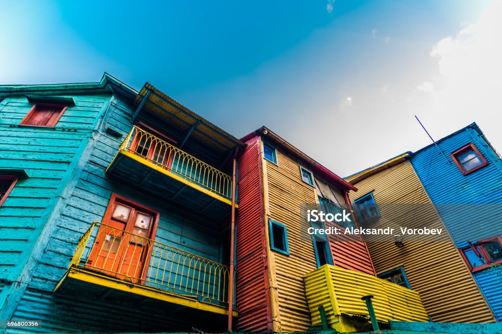 Traditional colorful houses on Caminito street in La Boca neighborhood, Buenos Aires Orange, red, blue, and yellow traditional South America houses Buenos Aires Stock Photo