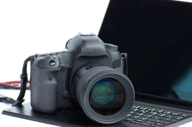 istock Close-up DSLR Camera lens on laptop. 696803384