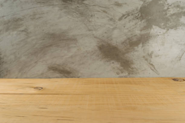 istock empty wooden board in front of blur concrete 696806164