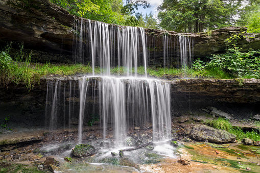 Water splashes over the two-tiered plunge of the waterfall at Oglebay Park in Wheeling, West Virginia.