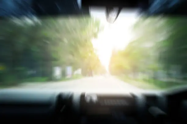 Abstract blur of a car running on the road at high speed or intoxication from alcohol