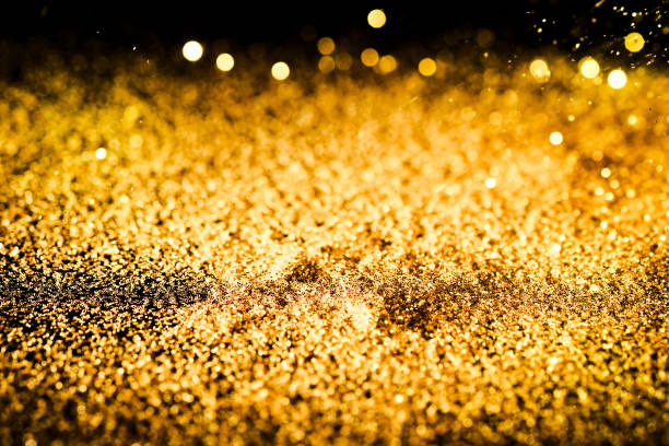 istock Sprinkle glitter gold dust on a black background ,abstract background texture 696810760
