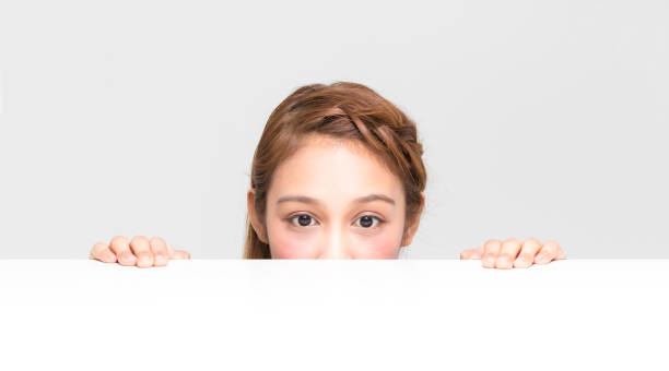 istock young girl staring something on the white table 696814244