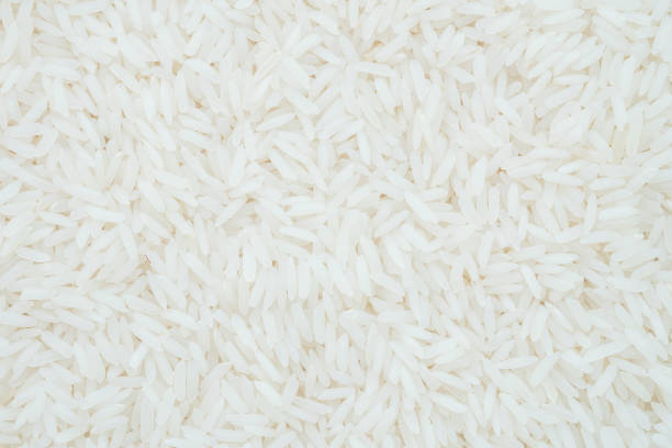 istock Closeup pile of white rice called jasmine rice textured background 696814530