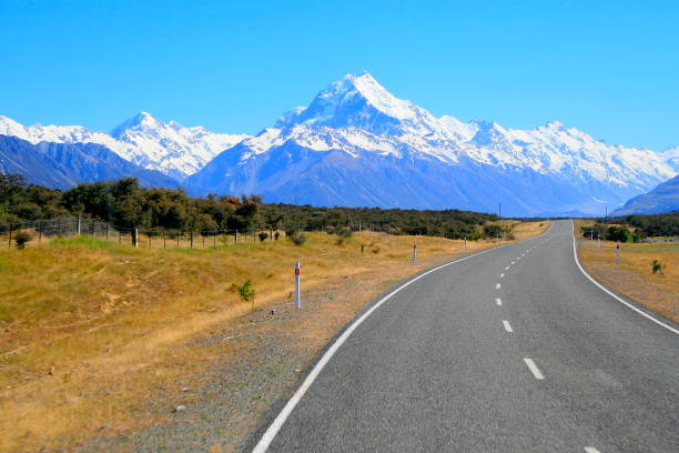 istock Road going into Majestic Mount Cook snowcapped mountain Range from the Canterbury Road, Canterbury, idyllic South New Zealand 696820320
