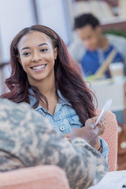 istock Confident female college student talks with army recruiter 696824188