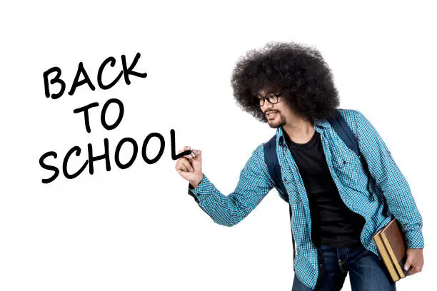 College student writing back to school text on white virtual screen while holding book, isolated on white background