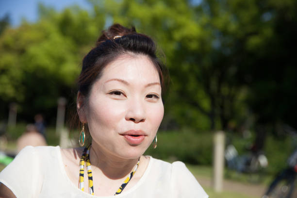 istock Japanese woman in a park 696838772