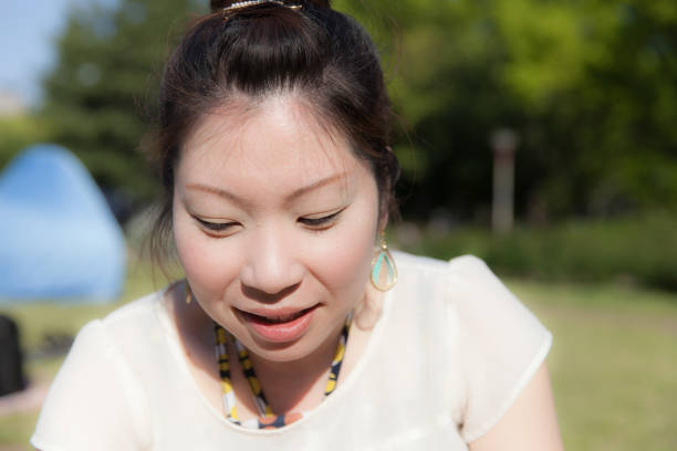 istock Japanese woman in a park 696838944