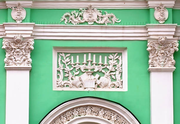 Detail of the gray buildings wall with  columns, white applications and stucco of the end of the nineteenth century