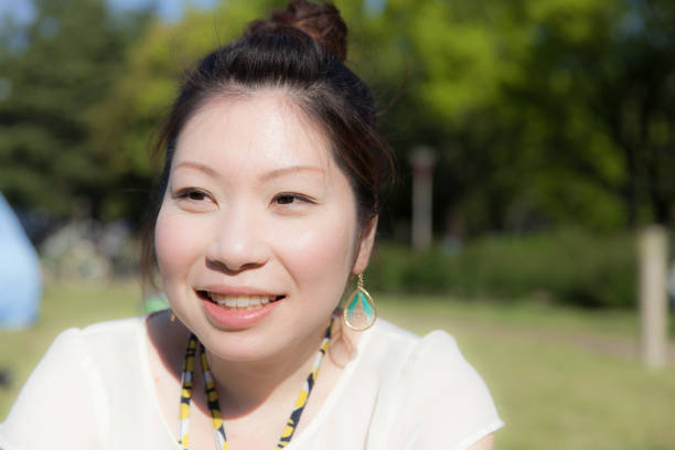 istock Japanese woman in a park 696842498