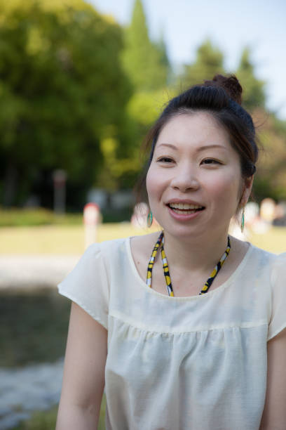 istock Japanese woman in a park 696842546