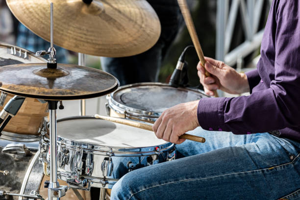 istock hands of musician while playing drums during street concert 696845568