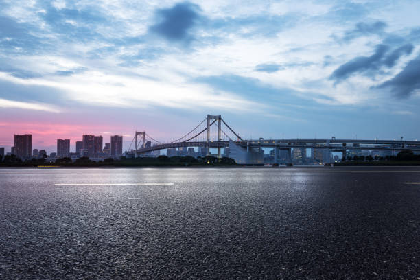 istock empty road with suspension bridge in modern city 696849932