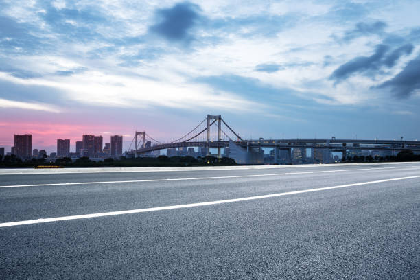 istock empty road with suspension bridge in modern city 696853132
