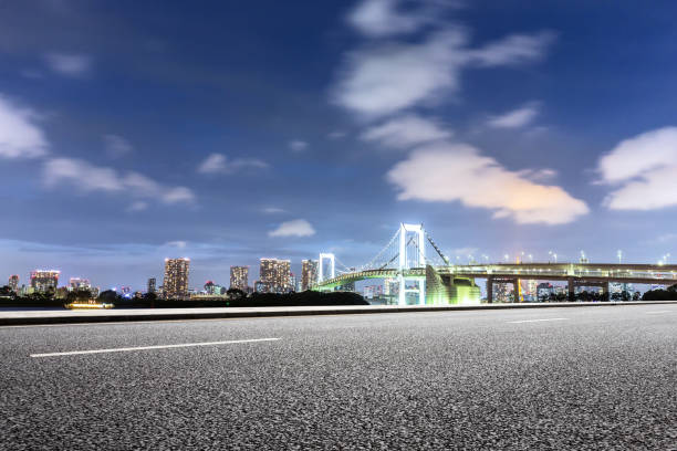 istock empty road with suspension bridge in modern city 696853440