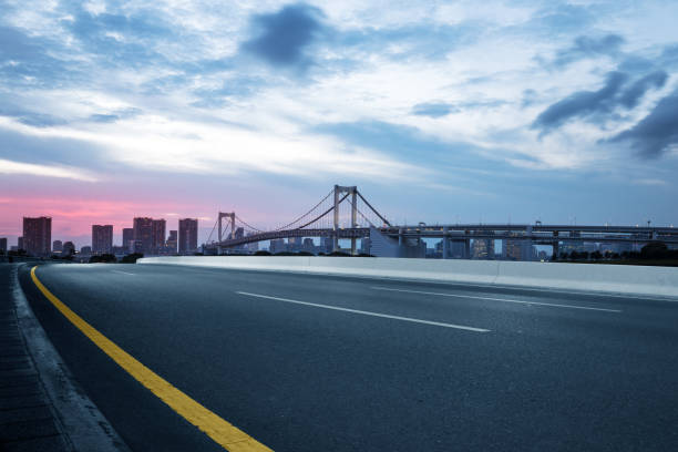 istock empty road with suspension bridge in modern city 696856128
