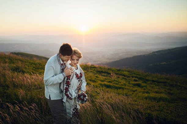 istock happy couple posing at mountains 696857060