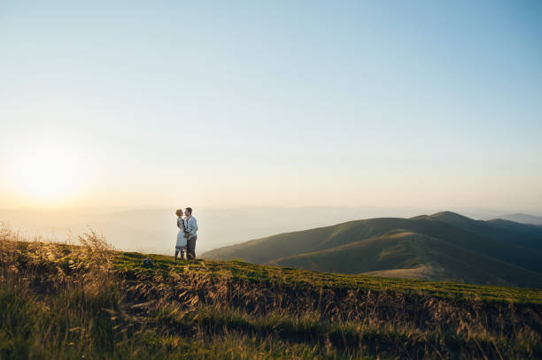 istock happy couple posing at mountains 696857104