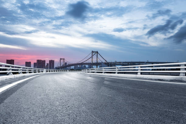 istock empty road with suspension bridge in modern city 696860256