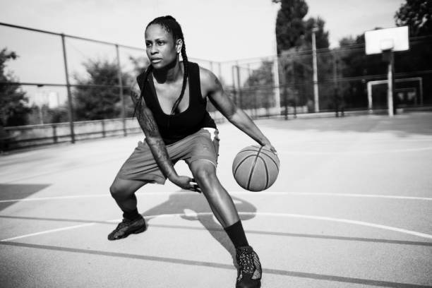 Fierce female basketball player Fierce female basketball player dribling ball. bouncing photos stock pictures, royalty-free photos & images
