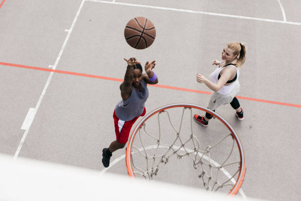 istock Two young woman playing basketball 696861798