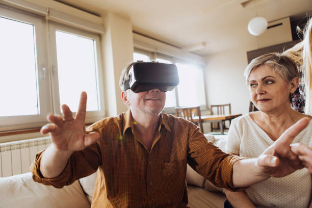 istock Older man trying out VR glasses for the first time 696866000