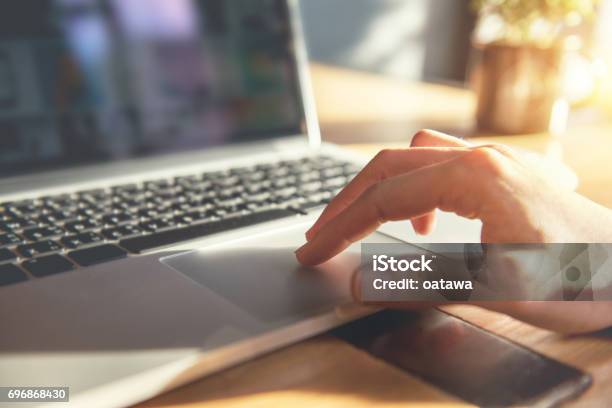 Woman Hand Using Touchpad On Laptop At Home Stock Photo - Download Image Now - Computer Mouse, Web Page, Examining