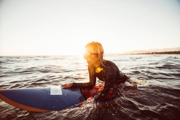 istock Female surfer floating on water 696869666