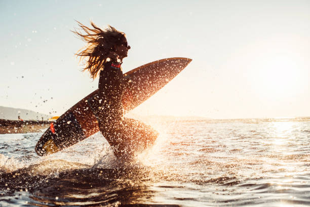 istock Woman preparing to surf 696869908