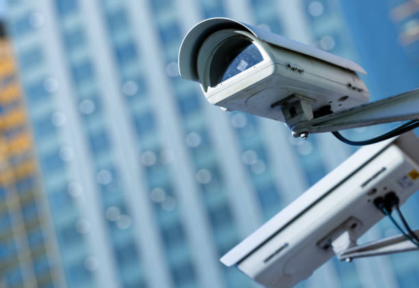 istock cctv security camera in a city with blury business building on background 696870028