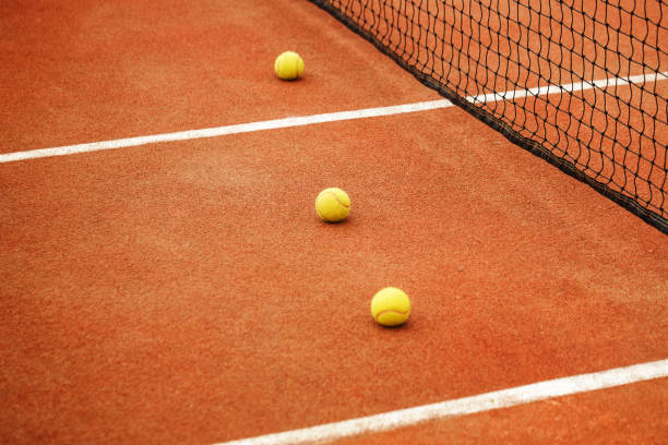 istock Ball on tennis court background 696872726