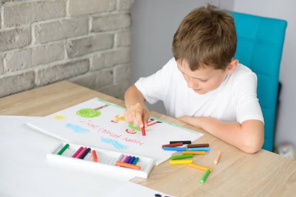 istock Child draws a drawing of happy son and father 696877046