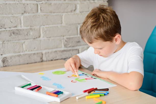 istock Child draws a drawing of happy son and father 696877280
